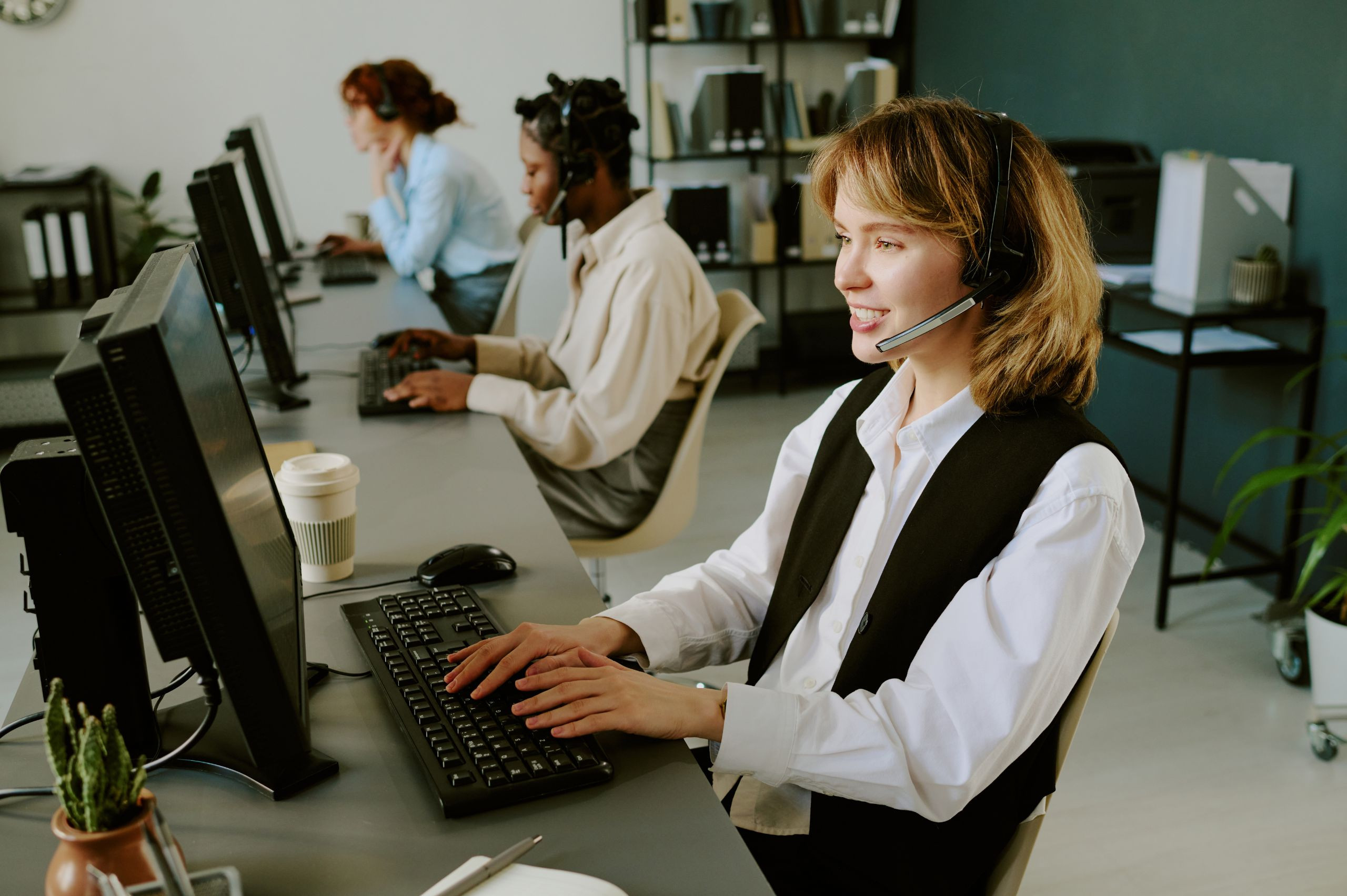 a woman taking a call at a desk in a coworking space