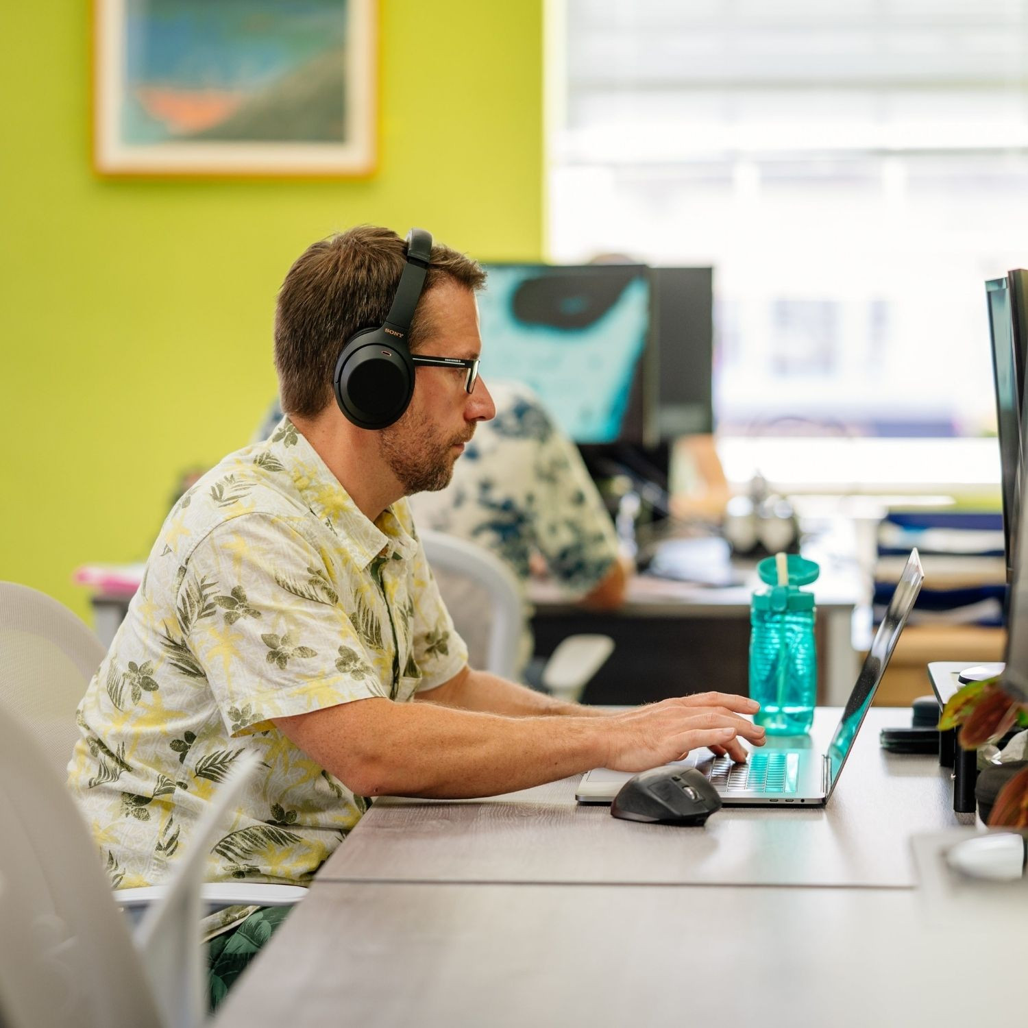 Man working at desk with headphones on