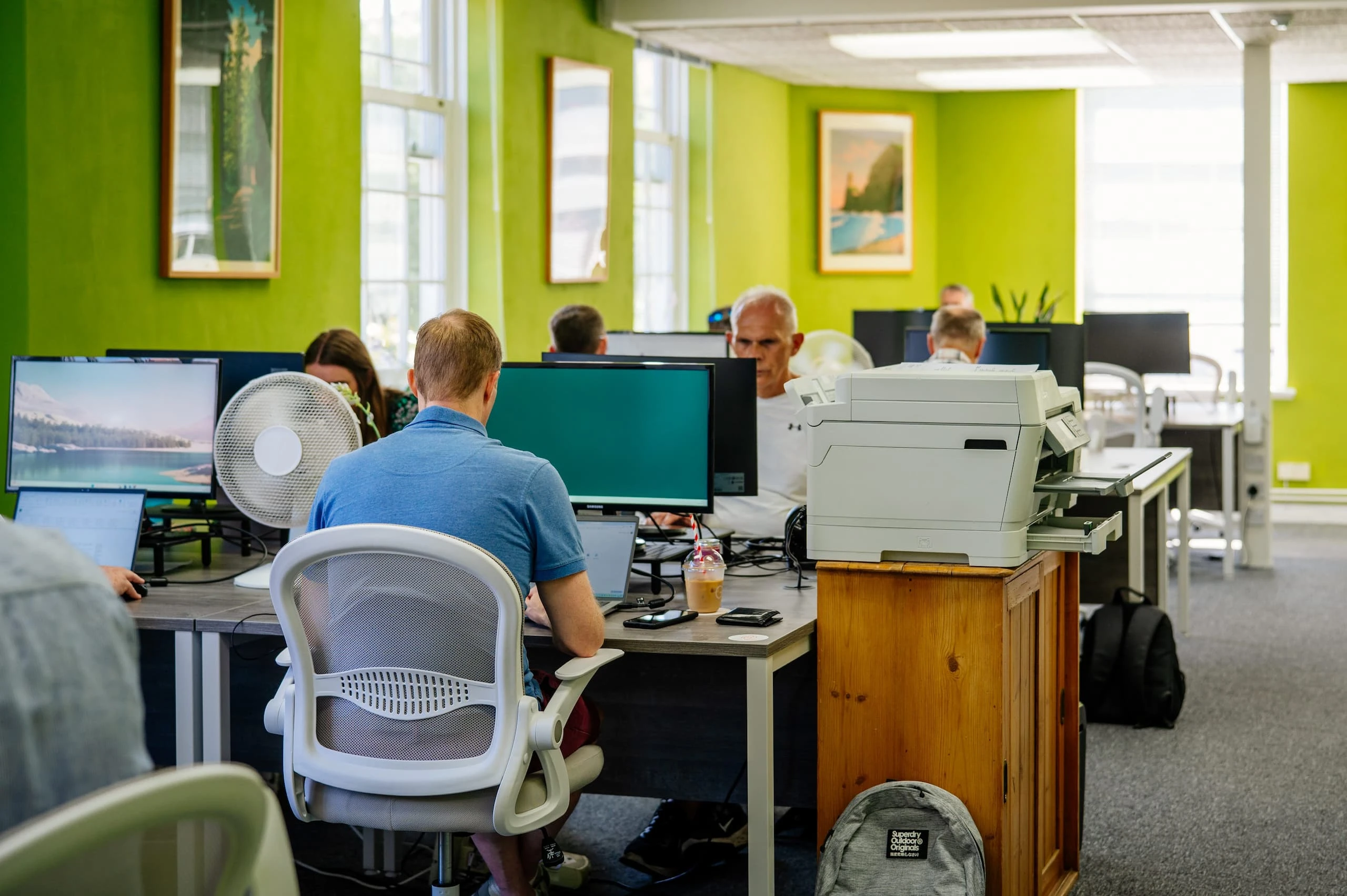 People sitting at desks in the Horsham Coworking office