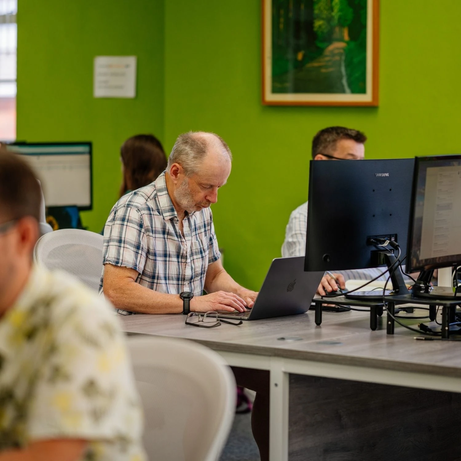 Clive working on his laptop in the coworking office space