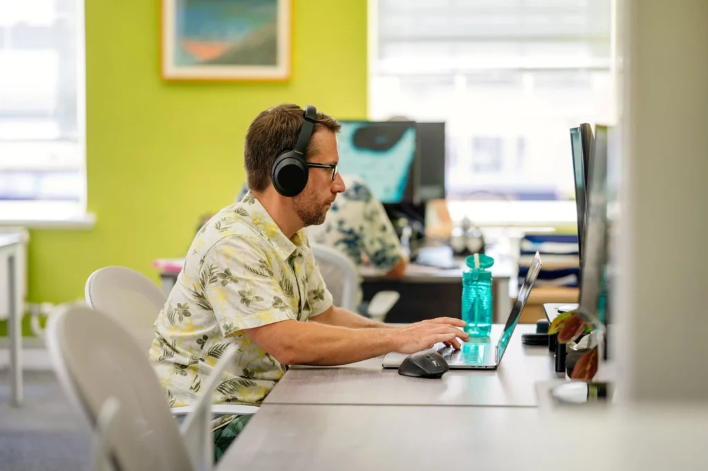 Man working at computer with headphones on