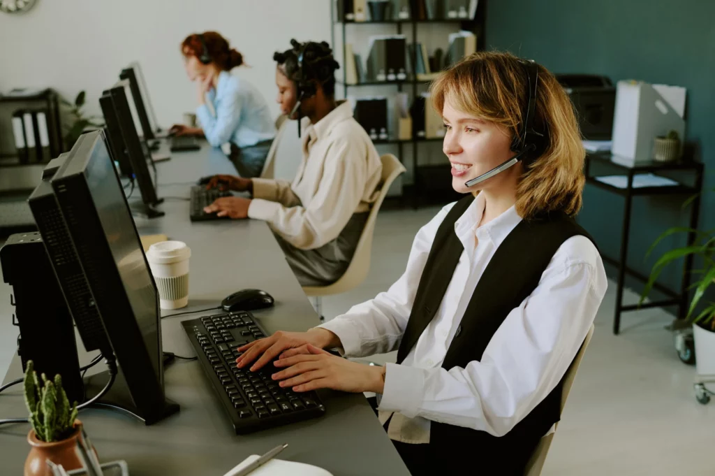 a woman taking a call at a desk in a coworking space