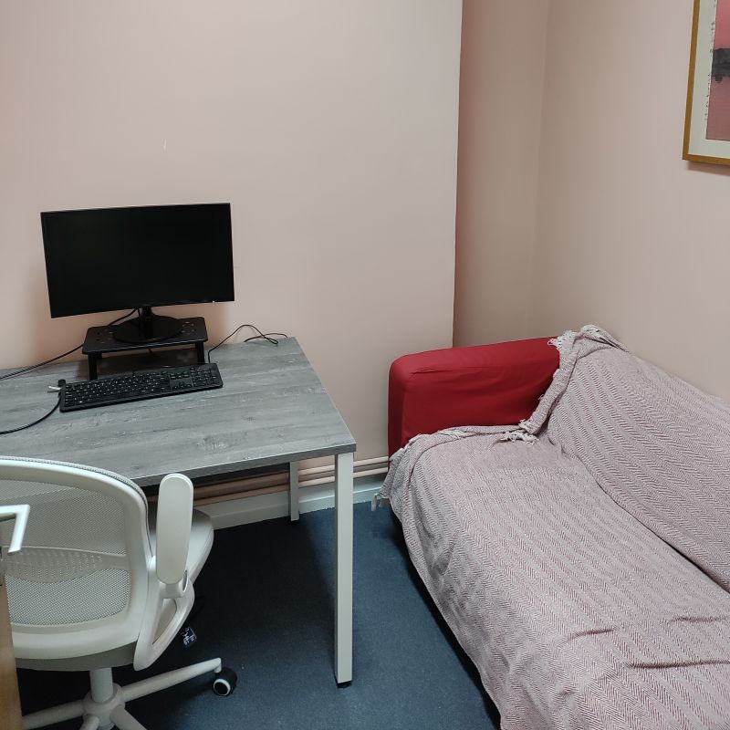 quiet room with desk and sofa